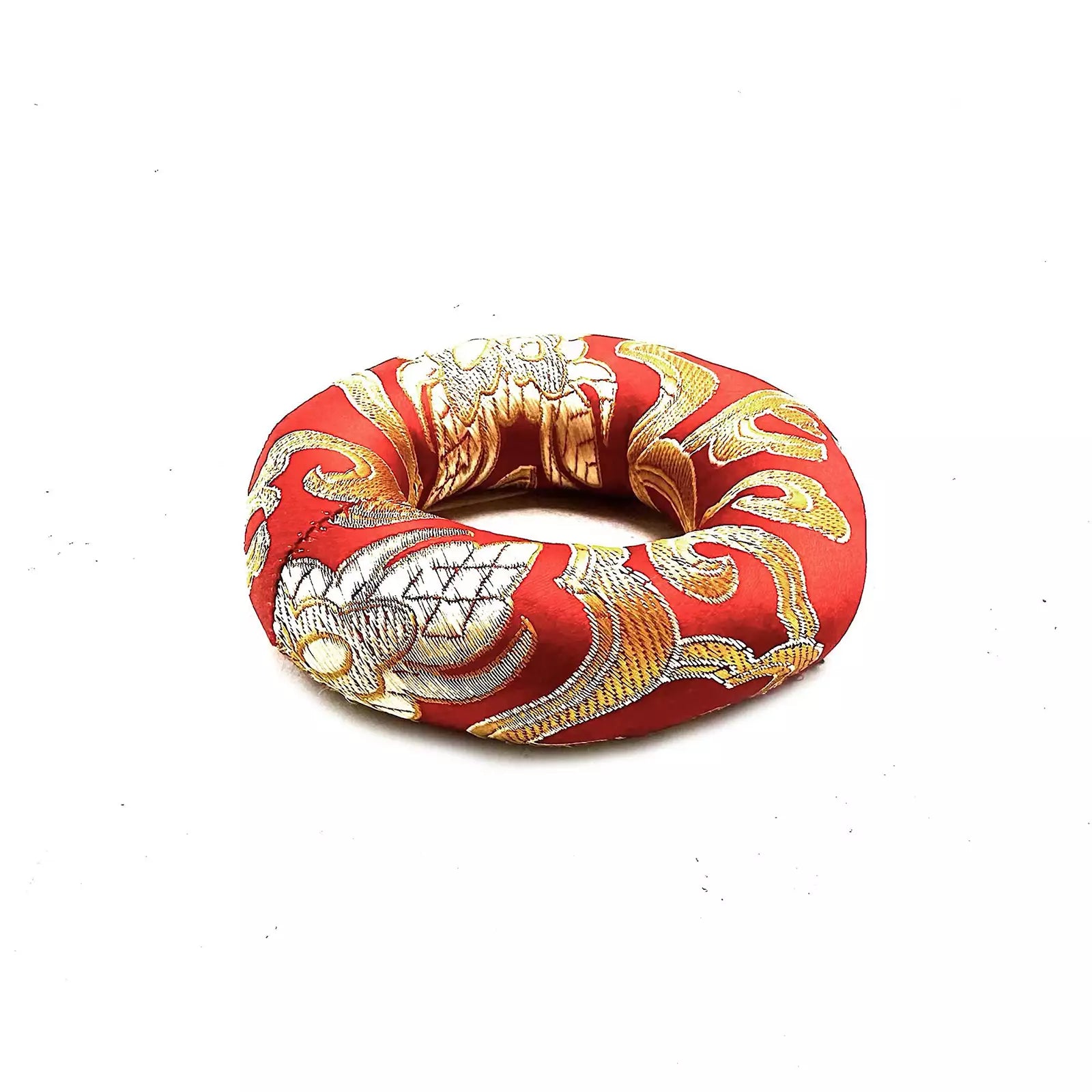 Decorative ring with red, gold, and white pattern on a white background