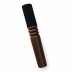 Wooden and black cylindrical object on a white background