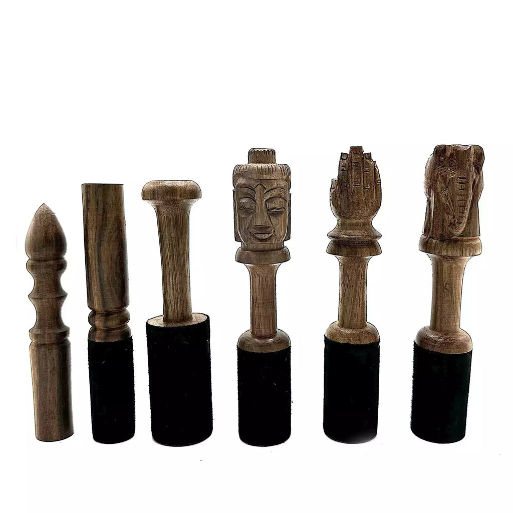 Set of wooden figurines with black bases on a white background