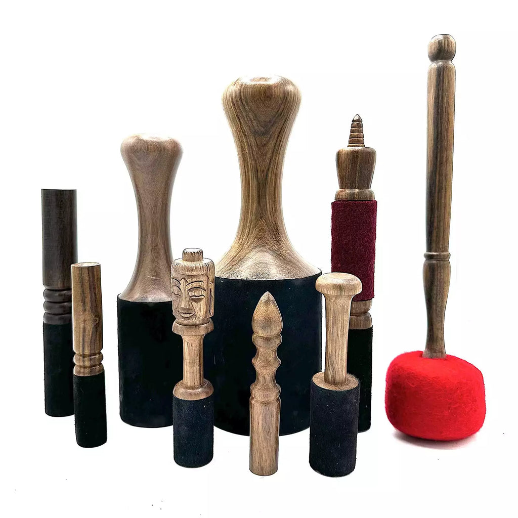 Collection of wooden and fabric-handled tools on a white background