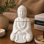 Sitting Buddha Oil Burner - White ceramic statue designed as a peaceful Buddha figure emitting gentle smoke from the top, perfect for calming home decor and aroma diffusion.