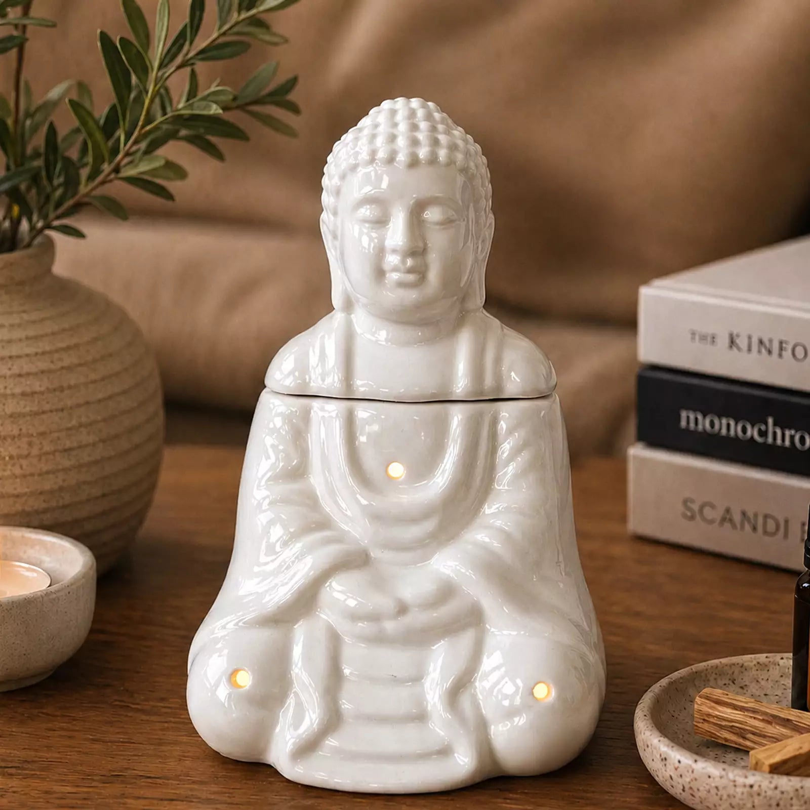 Sitting Buddha Oil Burner - White ceramic statue designed as a peaceful Buddha figure emitting gentle smoke from the top, perfect for calming home decor and aroma diffusion.