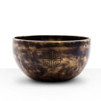 Small Indian Moon Phase Singing Bowl - (approx 550g) - 13cm with a smooth, polished brass finish and a traditional circular emblem on the side.