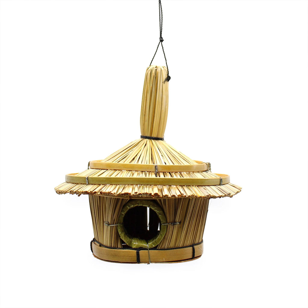 Small Round Seagrass Bird Box 17x17cm hanging from a tree branch in a garden setting, showcasing natural woven seagrass texture and round entrance hole.