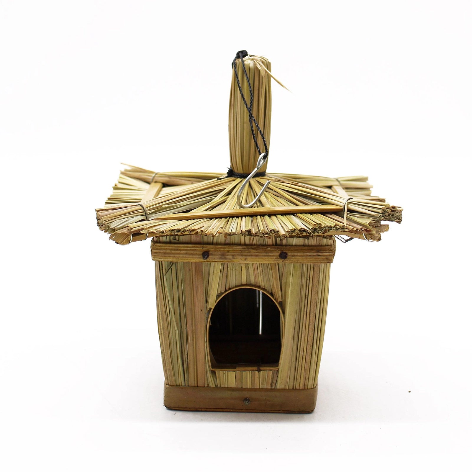 Small Square Seagrass Bird Box 18x13cm hanging from a tree branch outdoors, handcrafted from natural seagrass with a small entrance hole in a peaceful garden setting