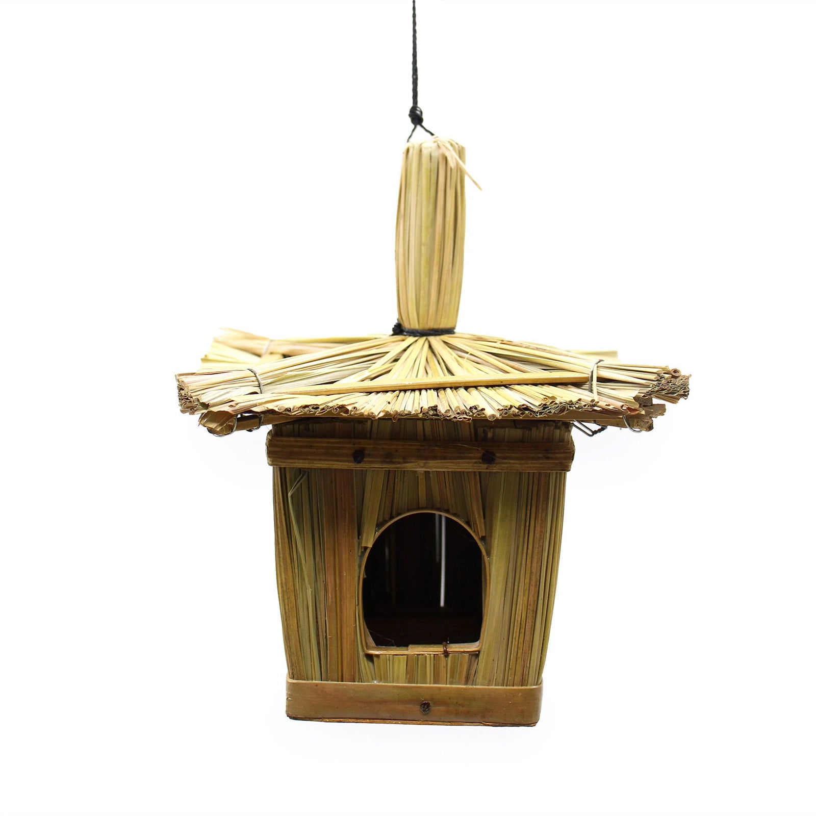 Small Square Seagrass Bird Box 18x13cm hanging from a tree branch outdoors, handcrafted from natural seagrass with a small entrance hole in a peaceful garden setting