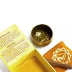 Gold chakra singing bowl with packaging on a white background