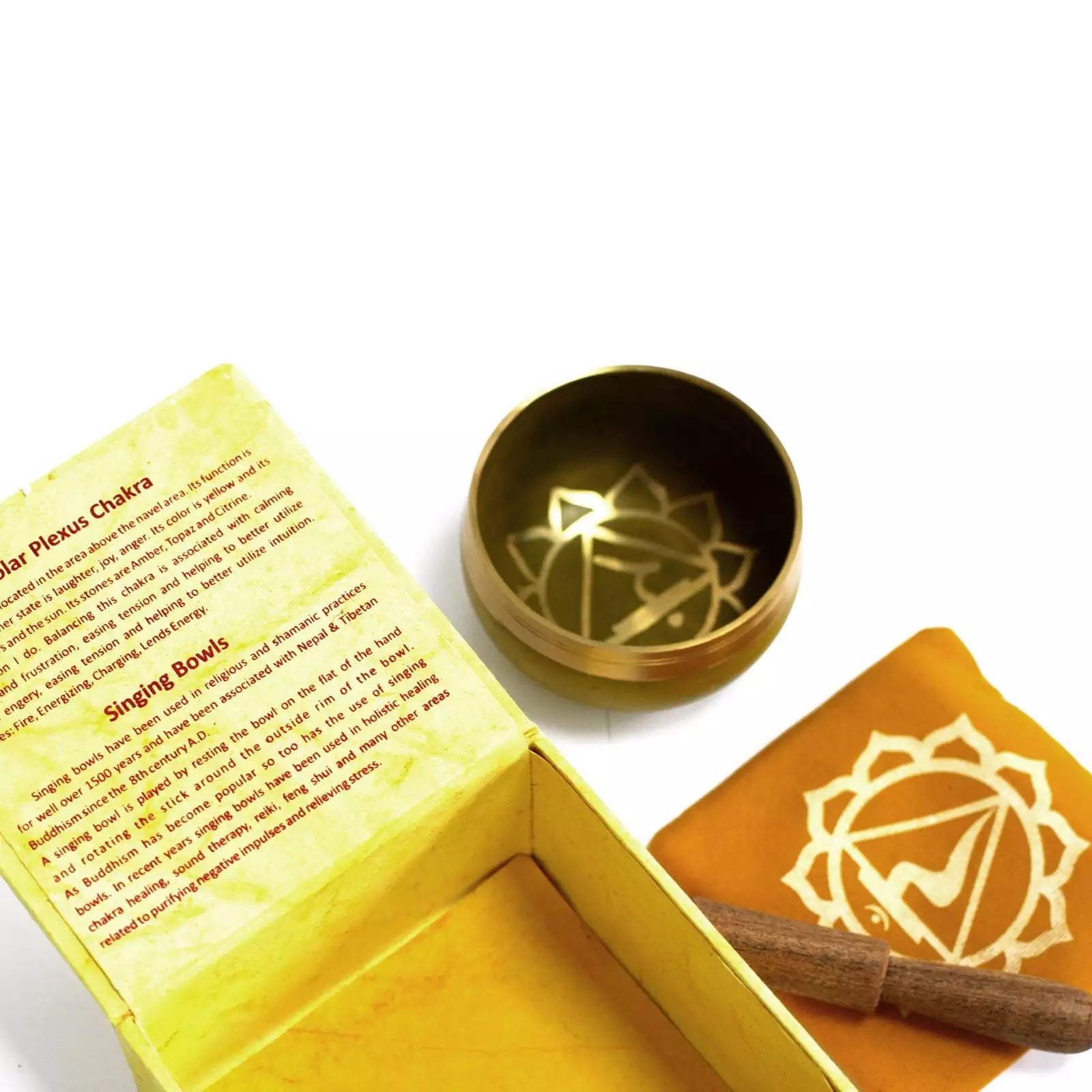 Gold chakra singing bowl with packaging on a white background