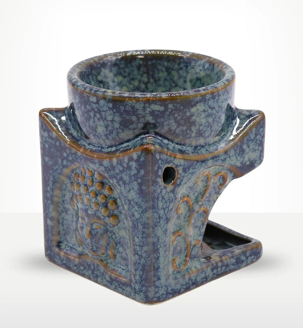 Square Buddha Burner - Dusty Blue ceramic oil burner with textured Buddha design and speckled glaze, combining serene decor with functional aroma diffusion.