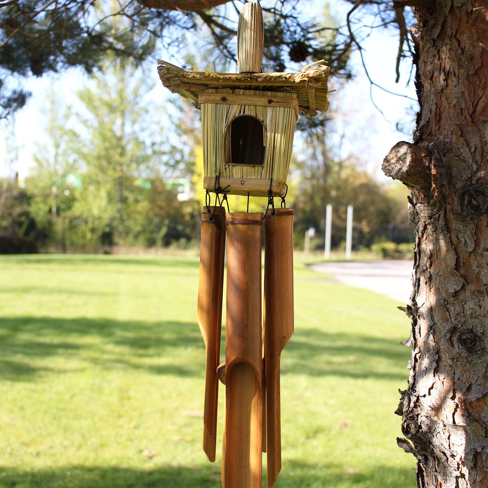 Square Seagrass Bird Box with Chimes 49x15cm featuring a natural woven seagrass birdhouse above bamboo wind chimes, designed for decorative outdoor or indoor use.