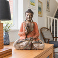 40 cm vintage orange wooden Buddha in a teaching pose on an oak hallway console.