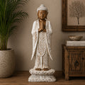 Wooden Buddha Statue Standing - Whitewash - 1m Welcome featuring a hand-carved design with serene expression and prayer hands, displayed as elegant Buddha decor in a calming room setting.