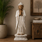 Wooden Buddha Statue Standing - Whitewash - 1m Welcome featuring a hand-carved design with serene expression and prayer hands, displayed as elegant Buddha decor in a calming room setting.
