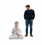 A hand carved Wooden Buddha Statue Whitewash - 30cm Teaching Transmission seated in meditation next to a man for size comparison, showcasing serene Buddha decor.