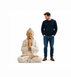 Man standing next to a large Wooden Buddha Statue Whitewash - 40cm Welcome, featuring a serene hand-carved design with light whitewashed finish and detailed texture.