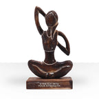 Wooden Yoga Lady - Antique - Cow Face Pose - "Stretch into Your Strength" depicts a hand-carved wooden figure in a seated yoga pose, symbolizing strength and mindfulness.