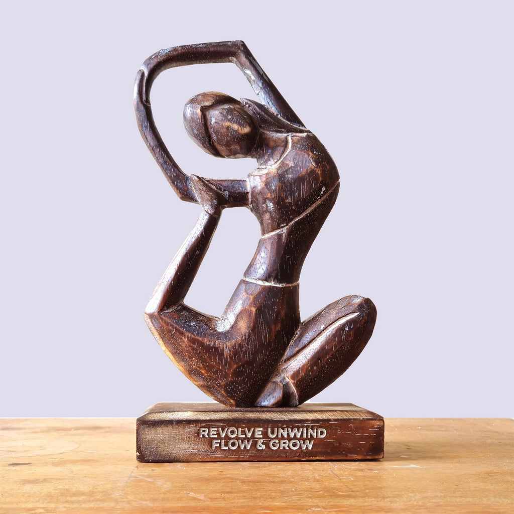 Wooden Yoga Lady - Antique - Revolved Pose - "Revolve Unwind - Flow & Grow" hand-carved wooden sculpture of a woman in a graceful, flowing yoga pose on a wooden base.