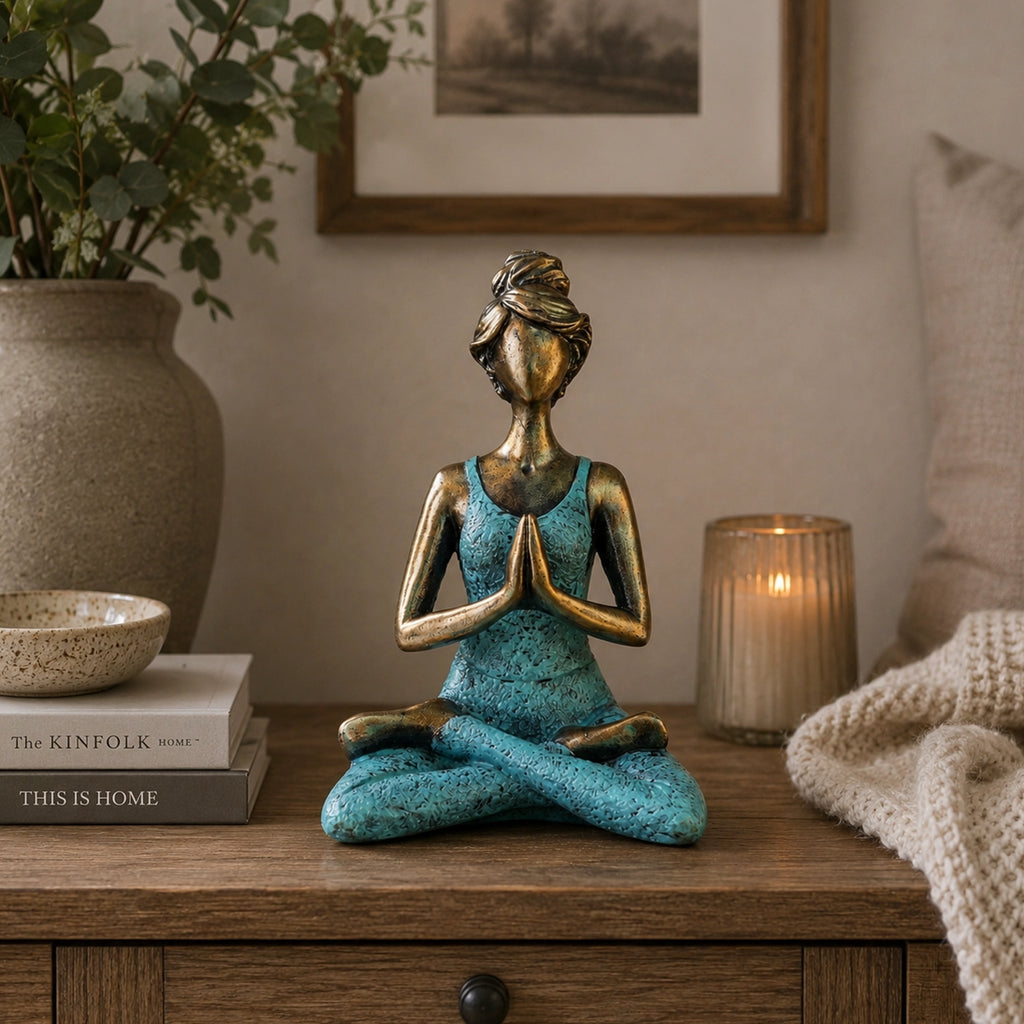 Yoga Lady Figure - Bronze & Turquoise 24cm depicts a serene woman in a seated yoga pose with hands in prayer, featuring a bronze finish and turquoise outfit.