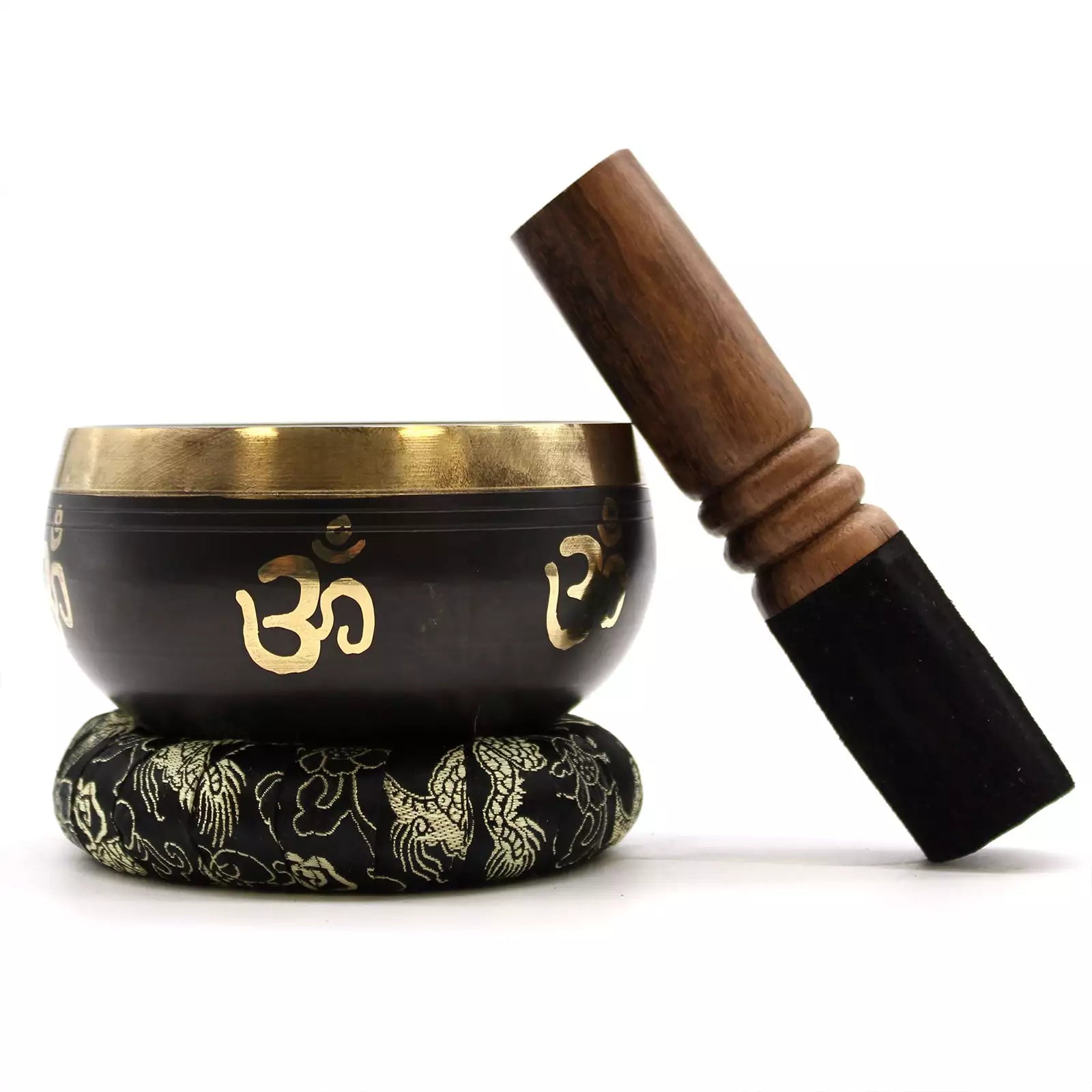 Black singing bowl with gold OM symbol, wooden striker, and black mat on a white background