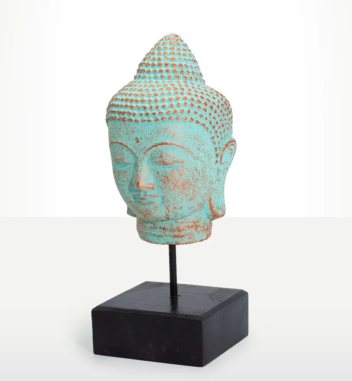 Stillness Buddha Head on Stand - Green Copper, a serene Buddha head sculpture with a green copper patina finish mounted on a black stand, ideal for Buddha decor and tabletop display.