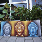 Buddha Painting - Three Heads Gold Detail featuring three serene Buddha heads in silver, gold, and blue tones with intricate swirl hair patterns, set against a textured background.