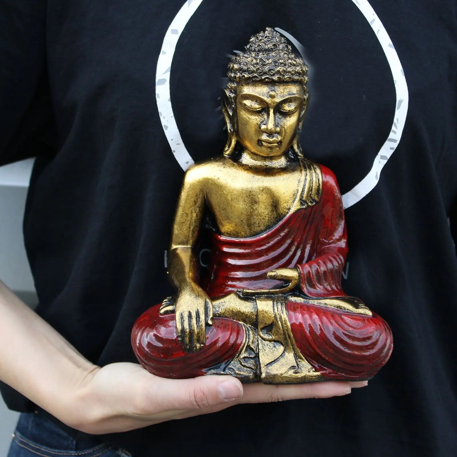 Person holding a hand-carved Red & Gold Buddha - Large statue featuring detailed gold and red robes in a meditative seated pose, perfect for Buddha decor.