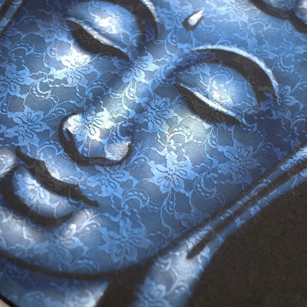 Close-up of a serene Buddha face with intricate blue brocade patterns overlaying the surface, highlighting delicate details in the Buddah Painting - Blue Brocade Detail.