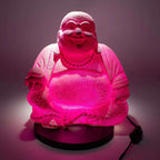 Illuminated Laughing Buddha Lamp Dragonfruit - Round Stand with textured, glowing pink resin surface sitting on a black circular base, featuring a serene smiling figure with beads.