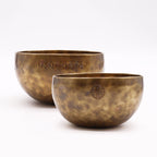 Two hammered brass bowls with engraved Nepalese script and circular symbol, showcasing traditional craftsmanship, styled for meditation or decor, Large Nepalese Moon Bowl - (approx 850g) - 17cm.