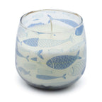 Medium Glass Jar Candles - Seabreeze featuring a clear glass container decorated with various blue fish illustrations, filled with white wax and a single wick.