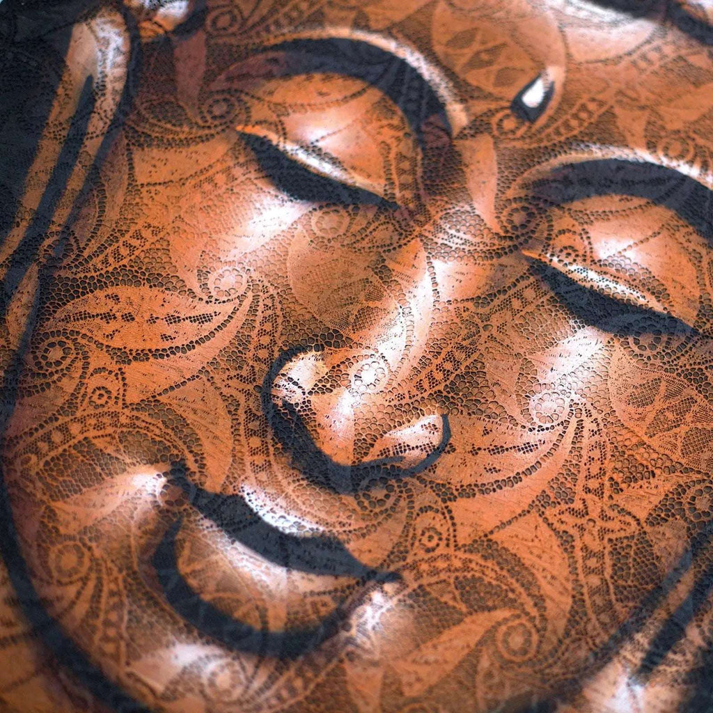 Close-up of a serene Buddha face with intricate copper brocade detail, showcasing delicate patterns in a Buddha Painting - Copper Brocade Detail.