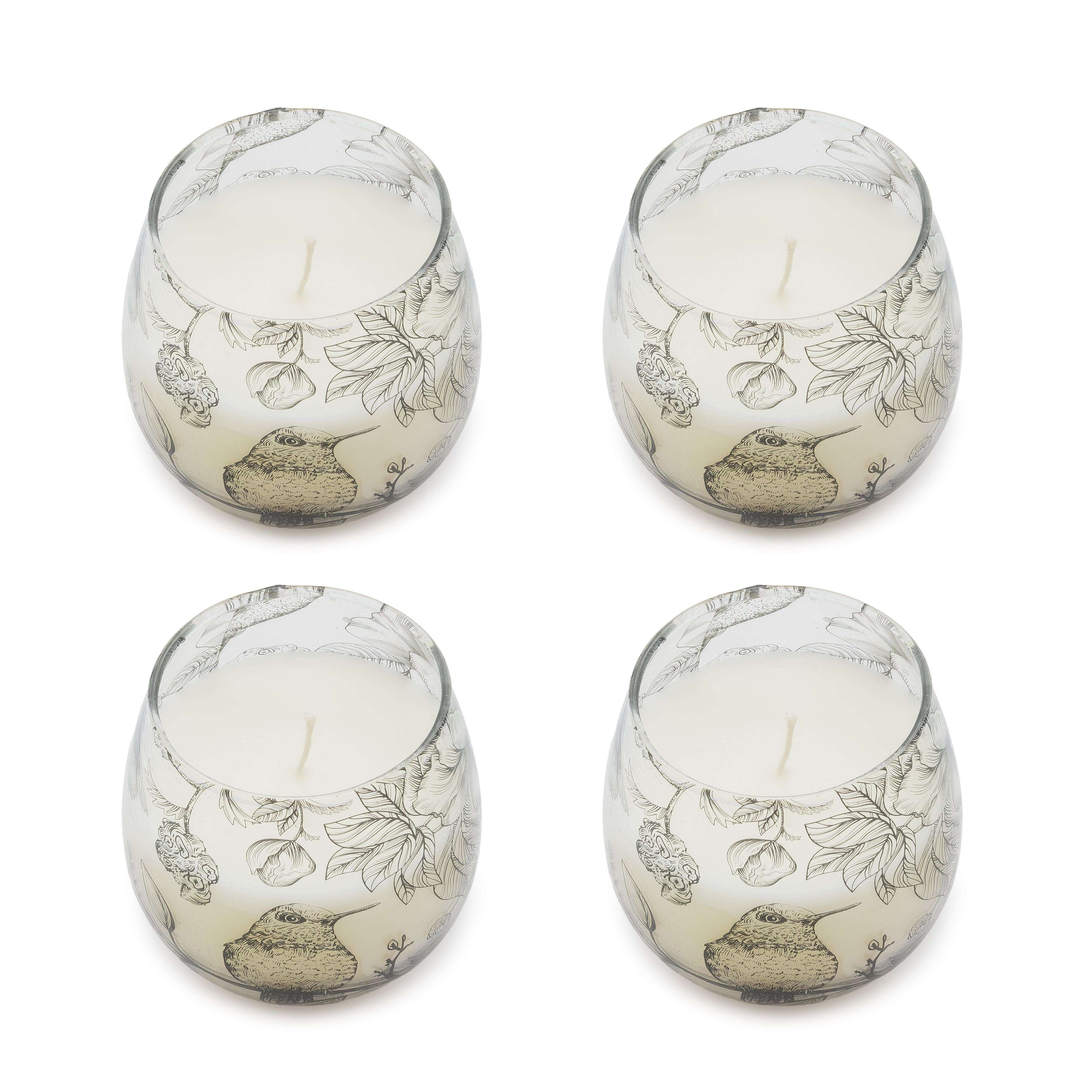 Four Small Glass Jar Candles - Drawn by Flame with intricate black botanical and bird illustrations on translucent glass, filled with white wax and a single wick.