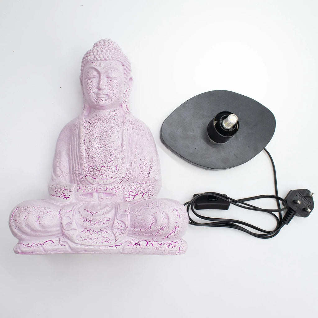 Meditation Buddha Lamp Cherry Crackle - Oval Stand shown disassembled, featuring a pink crackled resin Buddha statue and an oval black lamp base with a light bulb and power cord.