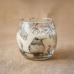 Small Glass Jar Candles - Drawn by Flame featuring a delicate bird and floral design etched on frosted glass, creating a warm and artistic ambiance.