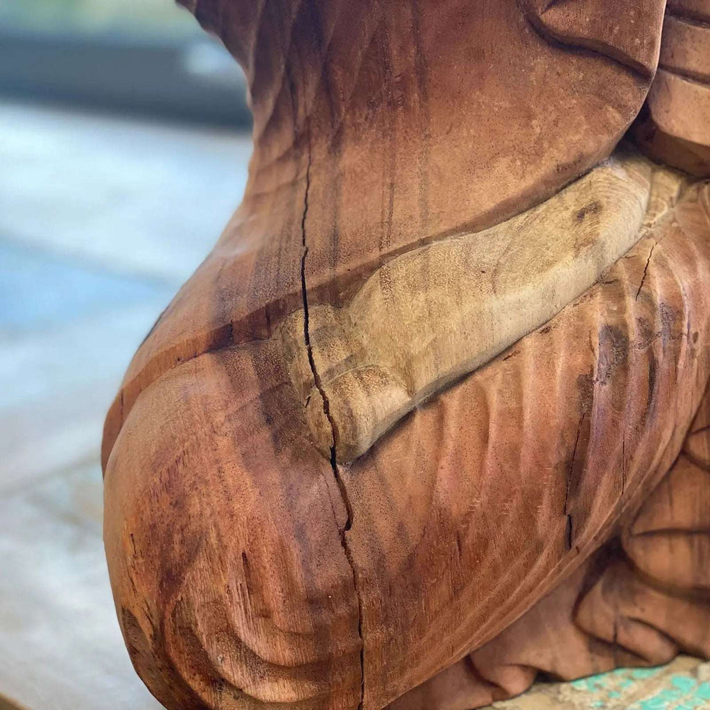 Close-up view of the intricate hand carvings and natural wood texture on the Hand Carved Buddha Statue - 40cm Welcome, showcasing detailed craftsmanship and a rich wooden finish.