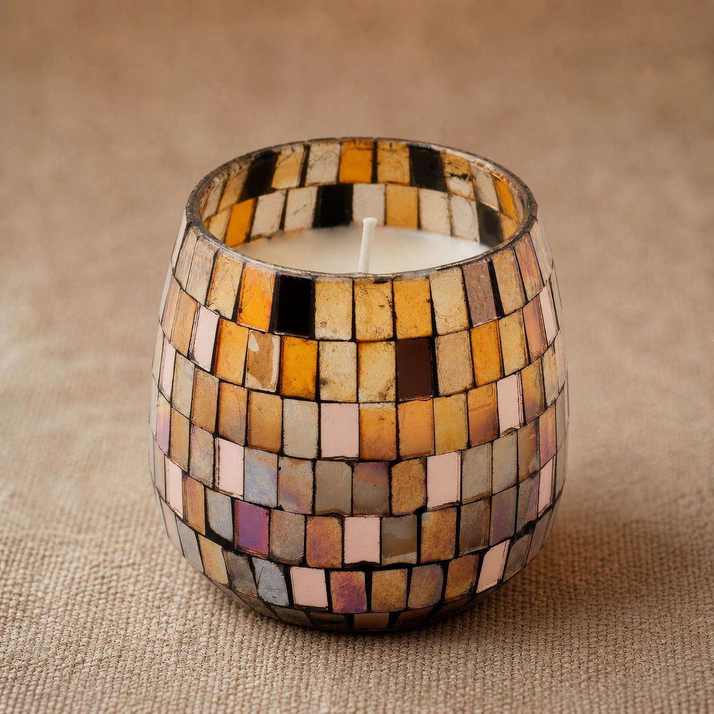 Medium Glass Jar Candles - Amber Mosaic with warm amber and gold mosaic glass pieces, creating a cozy and elegant ambiance on a neutral fabric surface.