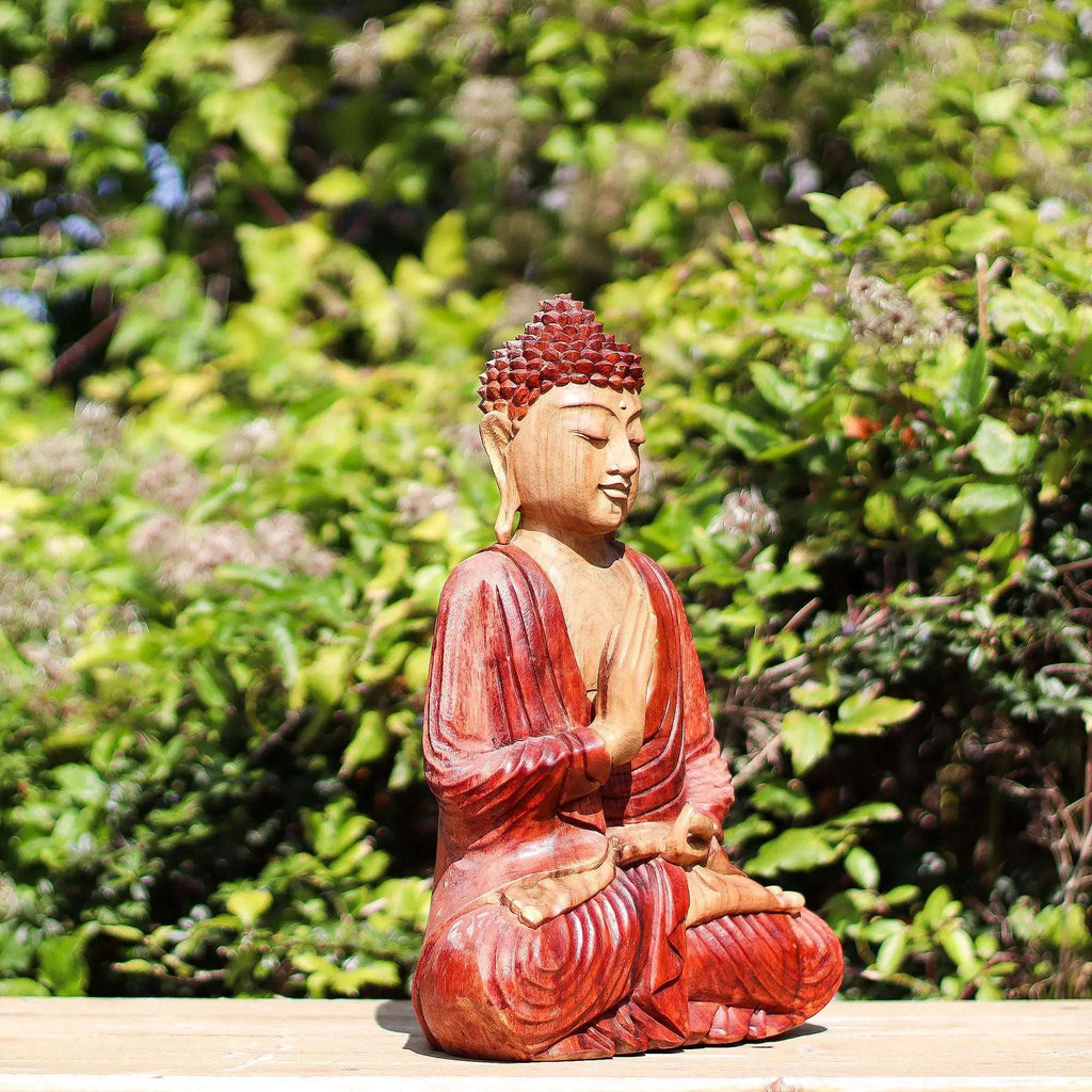 Hand Carved Buddha Statue - 30cm Teaching Transmission featuring a meditative pose with intricate details, set against a lush green natural background.