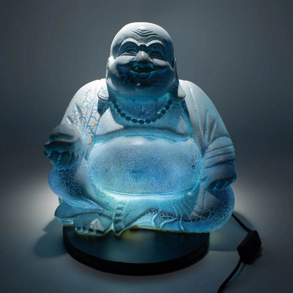 Laughing Buddha Lamp Sky Blue - Round Stand illuminated with soft blue light, handcrafted resin statue featuring a joyful Buddha sitting on a round stand, perfect Buddha decor.