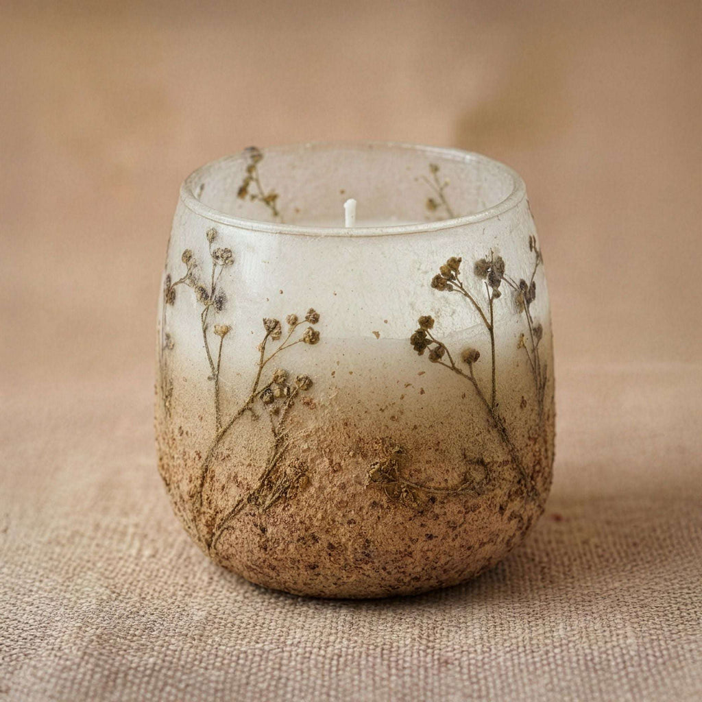 Medium Glass Jar Candles - Wildlight Woods featuring a rustic glass jar with embedded dried wildflowers and earthy tones, creating a natural and calming ambiance.