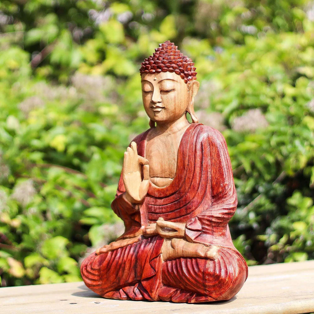 Hand Carved Buddha Statue - 30cm Teaching Transmission seated in meditation pose, crafted from wood with detailed carving and a serene facial expression, displayed outdoors.