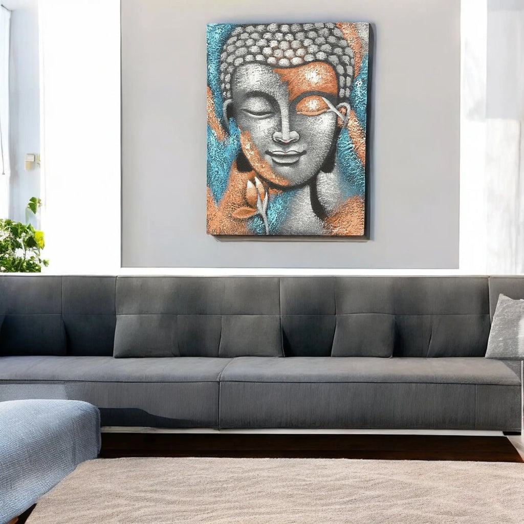 Buddha Painting - Silver & Rose Gold Flower 75x55cm depicting a serene Buddha face with silver and rose gold floral accents hanging on a light gray wall above a modern dark gray sofa.