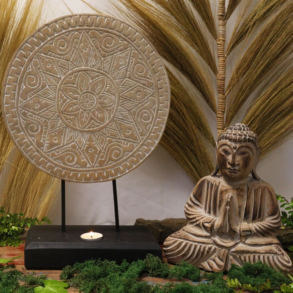 Decorative Buddha Feng Shui Set - Classic Mandala - Natural featuring a textured mandala plate on a stand and a seated Buddha statue placed among greenery and natural elements.