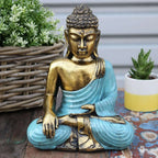 Teal & Gold Buddha - Large statue depicting a serene, hand-carved Buddha figure with teal robes and gold accents, ideal for peaceful home decor or meditation spaces.