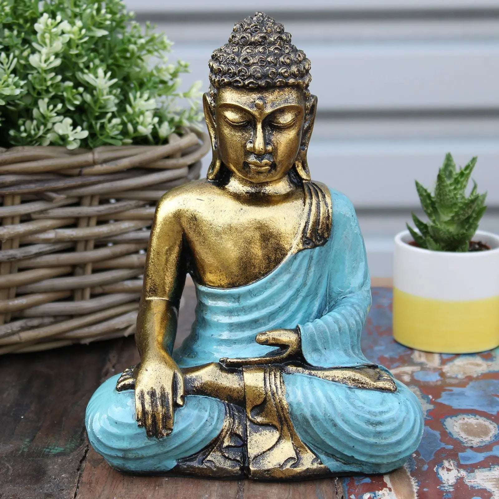 Teal & Gold Buddha - Large statue depicting a serene, hand-carved Buddha figure with teal robes and gold accents, ideal for peaceful home decor or meditation spaces.