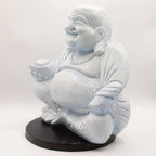Laughing Buddha Lamp Sky Blue - Round Stand featuring a textured sky blue resin Buddha statue seated on a round black stand, ideal for Buddha decor and Buddha glow lamps.