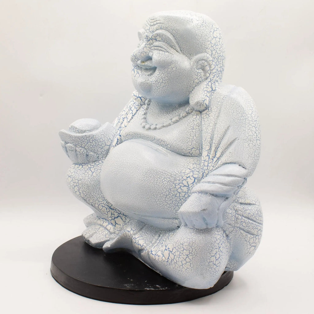 Laughing Buddha Lamp Sky Blue - Round Stand showcasing a hand-carved resin Buddha statue with a crackled sky blue finish, smiling and seated on a round black base.