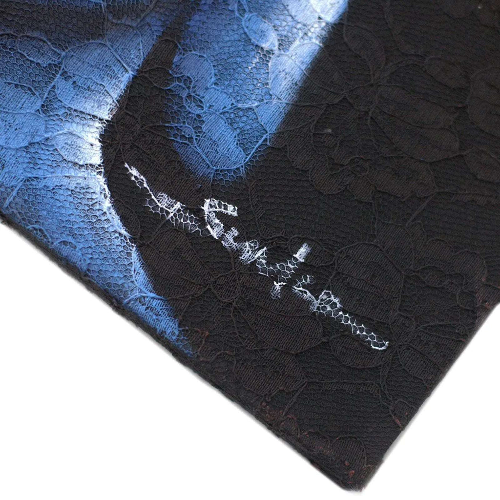 Close-up of the corner of the Buddha Painting - Three Heads Black, showing intricate floral lace textures and a subtle artist signature on the dark, serene background.