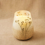 Tall Glass Jar Candles - Wildlight Woods with a natural beige and brown gradient glass jar featuring delicate pressed wildflowers, creating a warm and rustic ambiance.