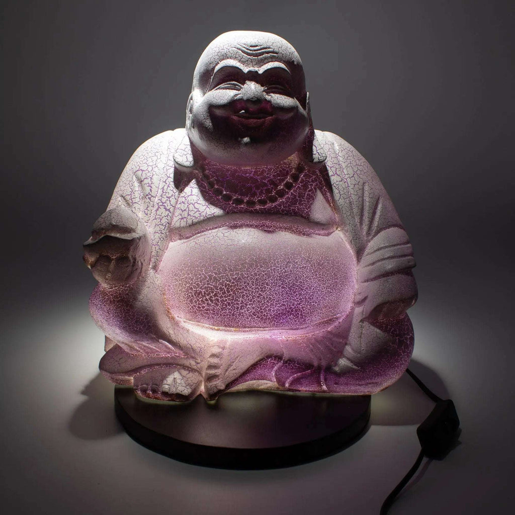 Laughing Buddha Lamp Lavender Crackle - Round Stand showcasing a glowing lavender crackle finish on a hand-carved Buddha statue sitting on a round black base with a power cord.