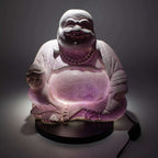 Laughing Buddha Lamp Lavender Crackle - Round Stand showcasing a glowing lavender crackle finish on a hand-carved Buddha statue sitting on a round black base with a power cord.